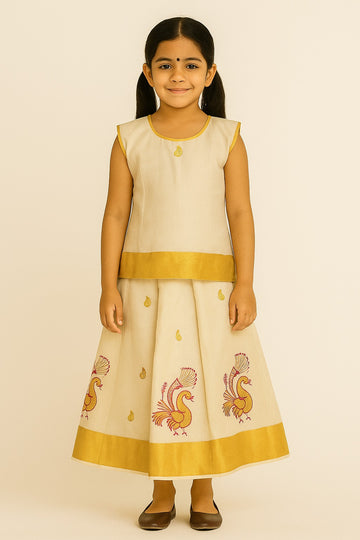 Traditional Off-White Pattu Frock for Girls – Sleeveless Ethnic Dress with Gold Zari Border & Pink Peacock Embroidery