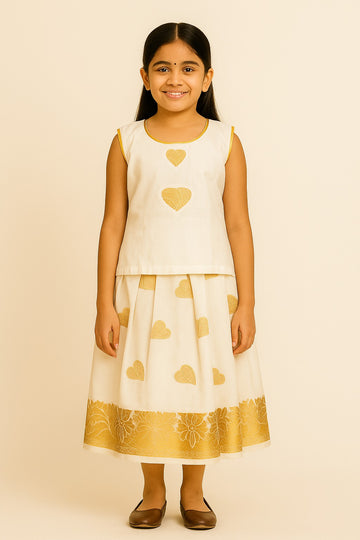 Off-White Traditional Pattu Frock for Girls – Sleeveless Dress with Golden Heart Motifs & Floral Zari Border